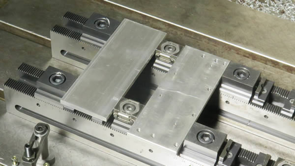 The modular workholding system Multi-Rail system clamps typically 6 to 12 workpieces at a time